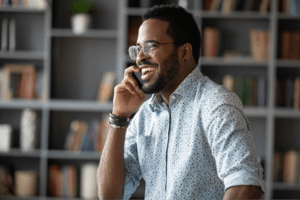 Man smiling while talking on his phone