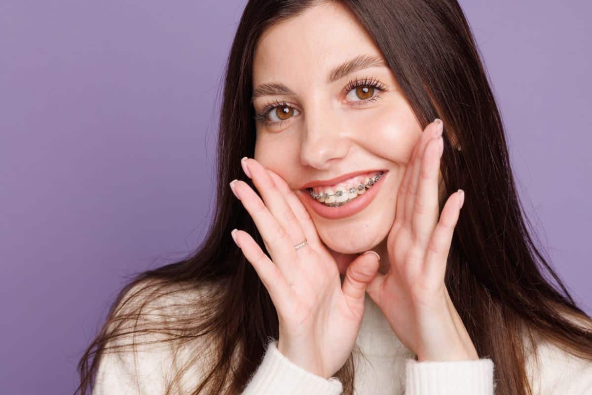 Patient smiling with braces during orthodontic treatment